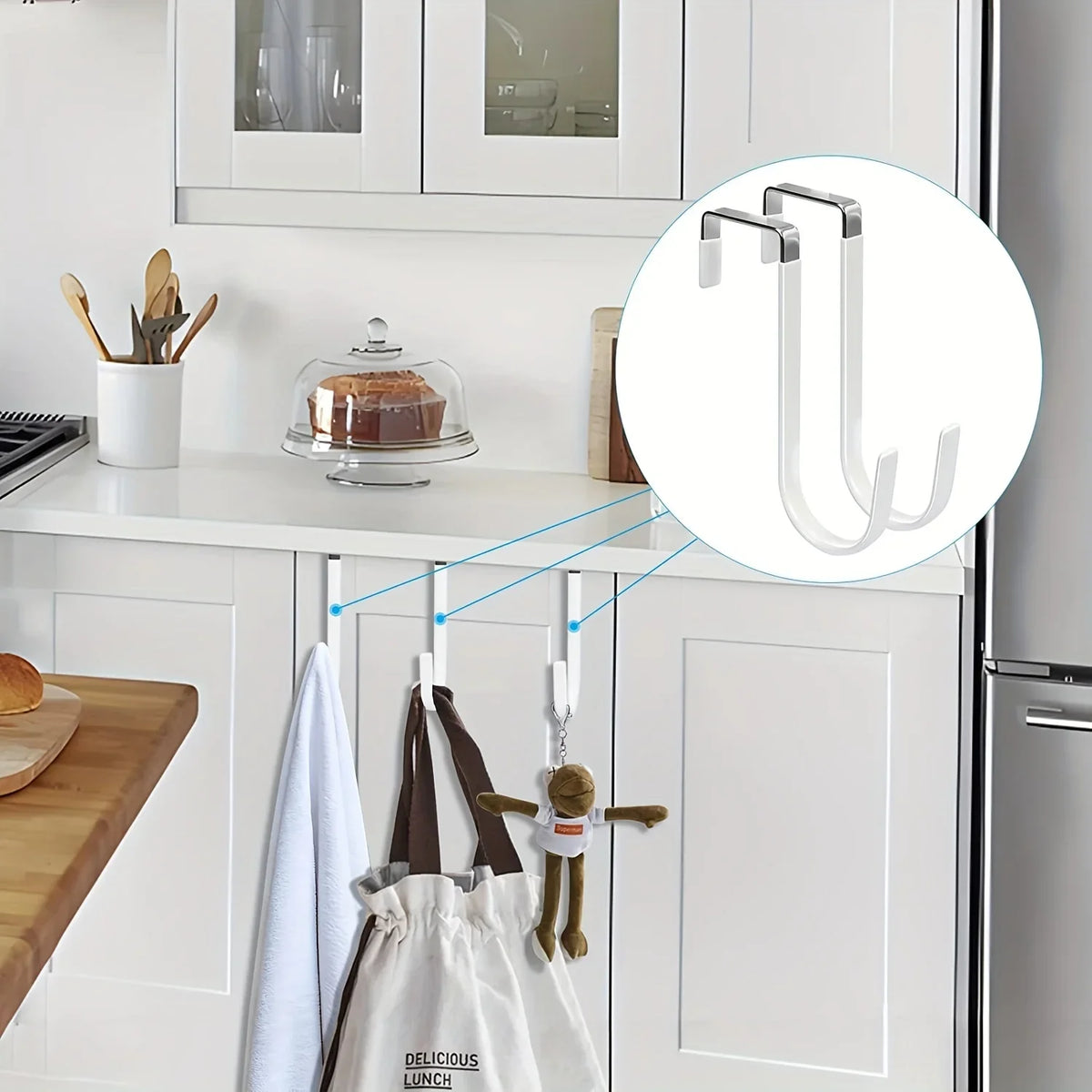 A set of heavy-duty door hangers with scratch-protective rubber coating hanging on a kitchen cabinet door.