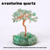 A natural aventurine quartz crystal tree featuring green and clear crystals on a base.