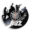 A black vintage vinyl record wall clock featuring silhouettes of musicians and a clock face.