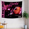 A black tapestry featuring pink text and an image of a woman in a car.