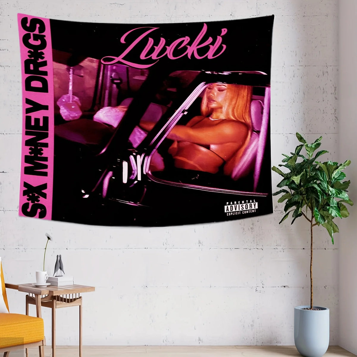 A black tapestry featuring pink text and an image of a woman in a car.