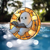 A round, sun-like decoration featuring a white ghost reading an open book, suspended by a chain.