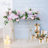 Gold geometric flower stands with pink and purple flowers decorating a table.