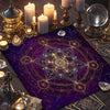 A purple altar cloth featuring intricate golden sacred geometry patterns and various divination tools.