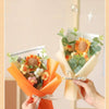 A handmade sunflower daisy crochet bouquet wrapped in orange paper and greenery.