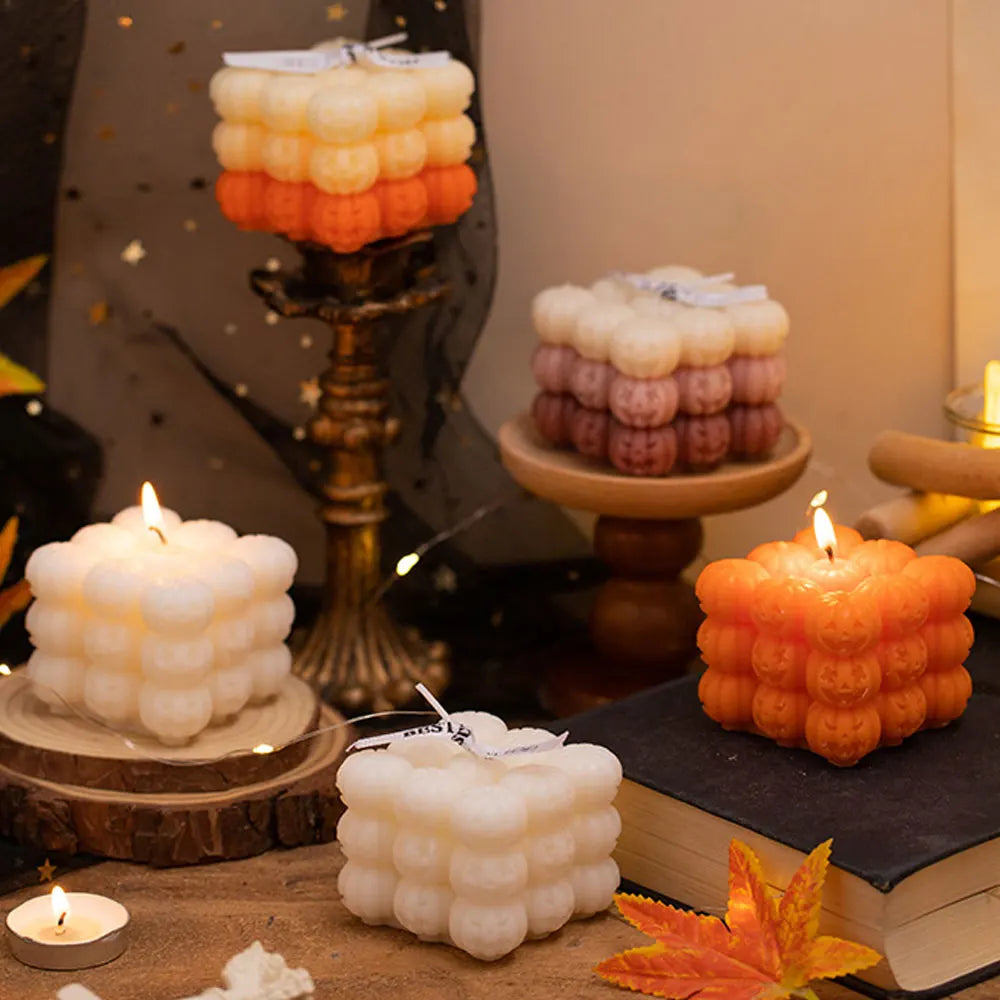 A collection of white and orange silicone pumpkin molds used for making candles and resin crafts.