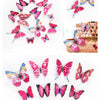A collection of twelve pink and multicolored 3D butterfly wall stickers in various shapes and sizes.