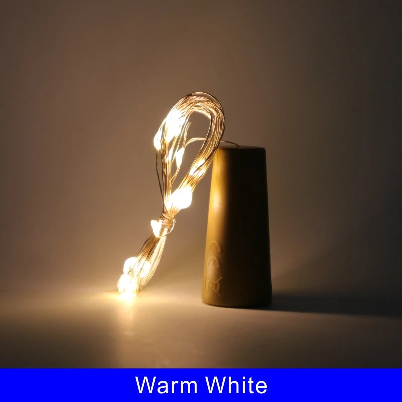 A single LED wine bottle cork light illuminates a dark amber glass bottle.