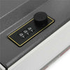 A black combination lock device with a rotating dial and four numbered buttons is shown on a dark surface.