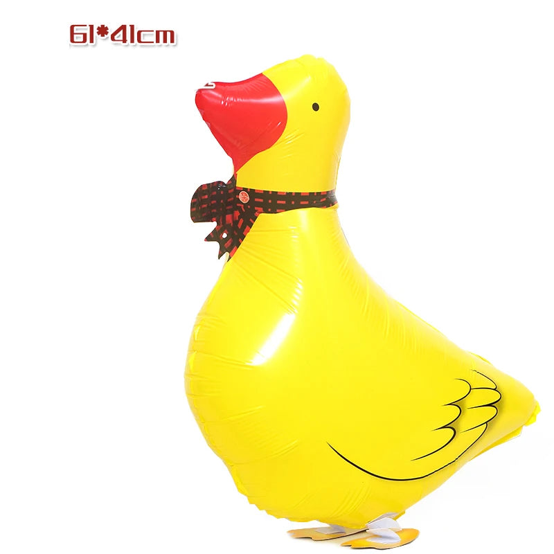 A yellow cartoon duck foil balloon with a red beak and black scarf.