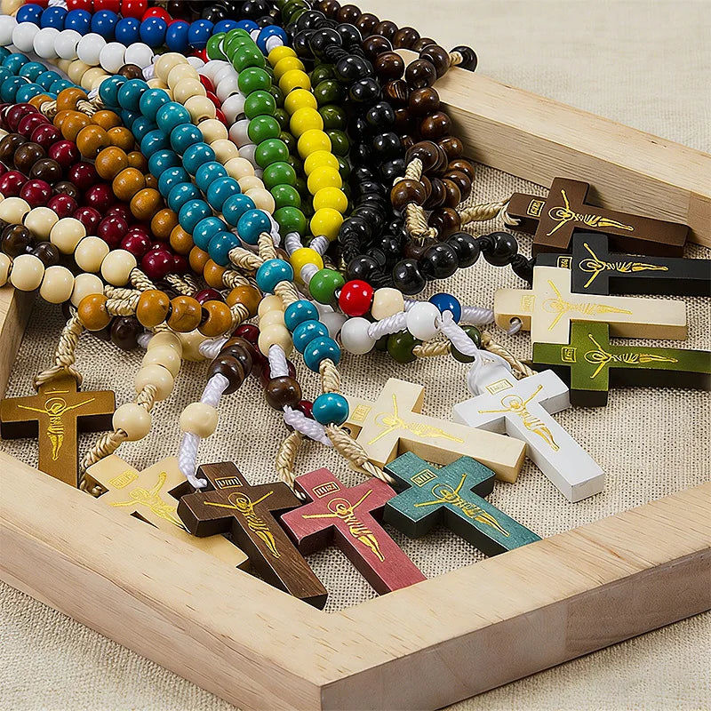 A wooden rosary beads necklace featuring various colored beads and a Jesus crucifix, displayed in a wooden frame.