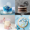 A tiered cake decorated with blue and white frosting and floral accents, set against a light blue background.