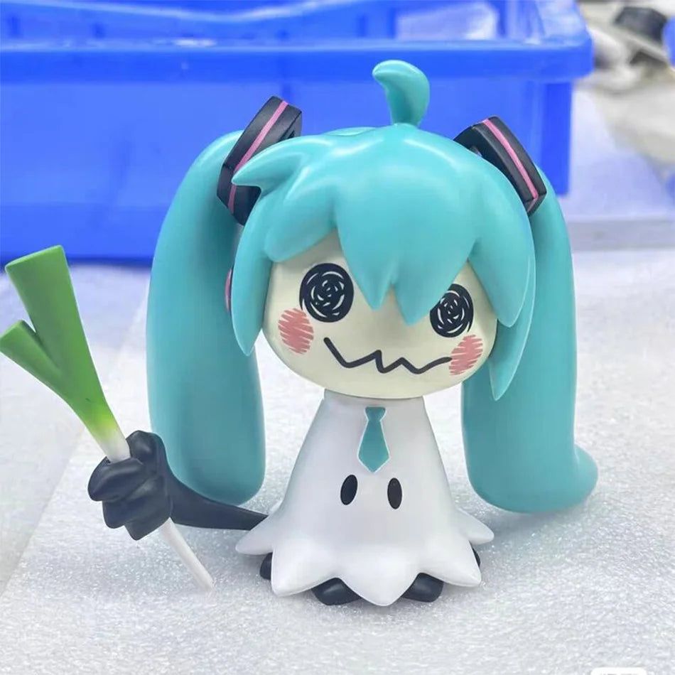 A light blue Hatsune Miku anime figurine with long hair and a white shirt and tie.