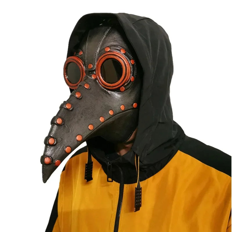 A person wearing a black plague doctor bird mask and a yellow hooded jacket.