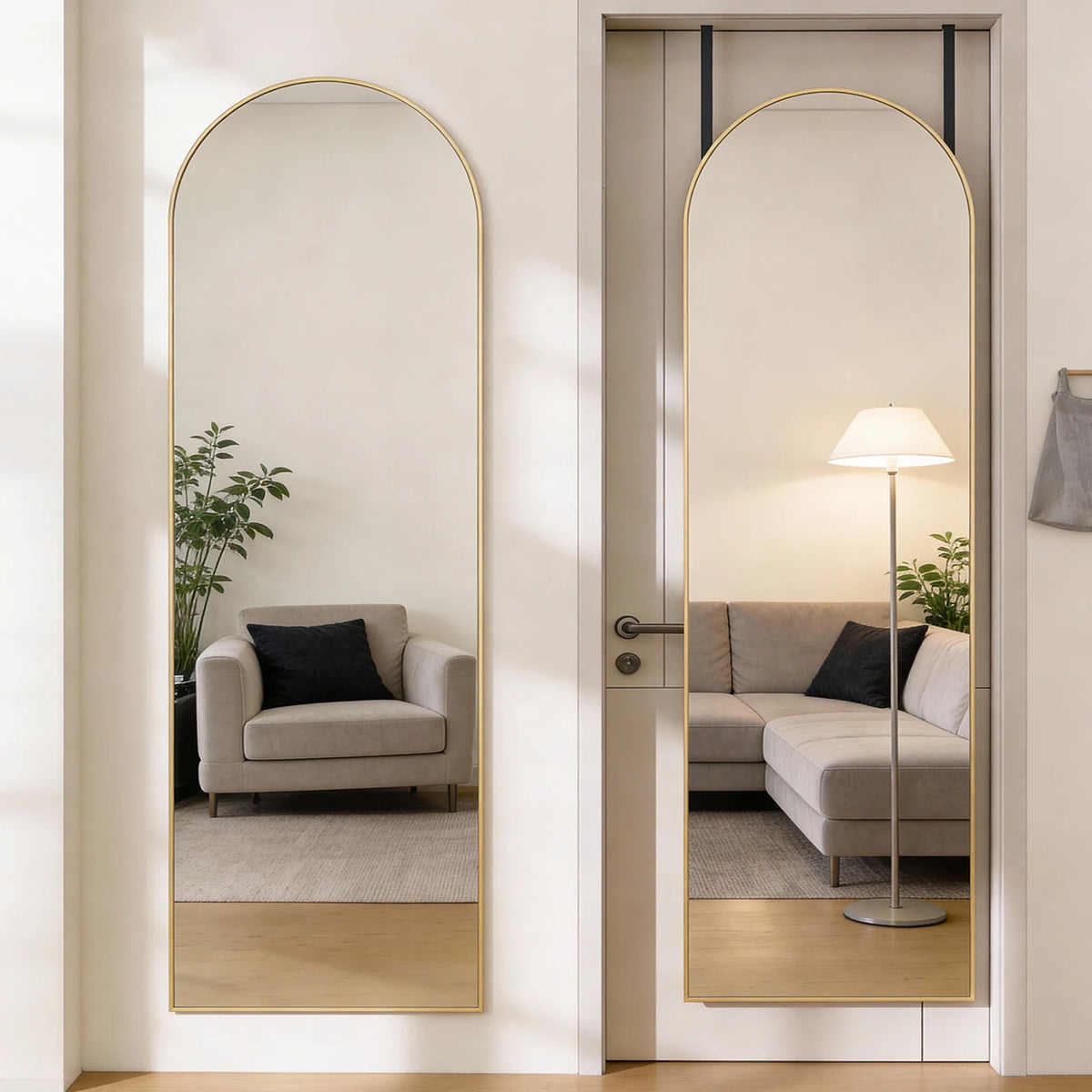 A full-length arched wall mirror with a gold aluminum frame reflecting a modern living room interior.