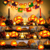 String lights shaped like orange marigolds decorating a festive display.