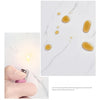 A set of ten glossy amber self-adhesive marble tile stickers placed on a white marble background.