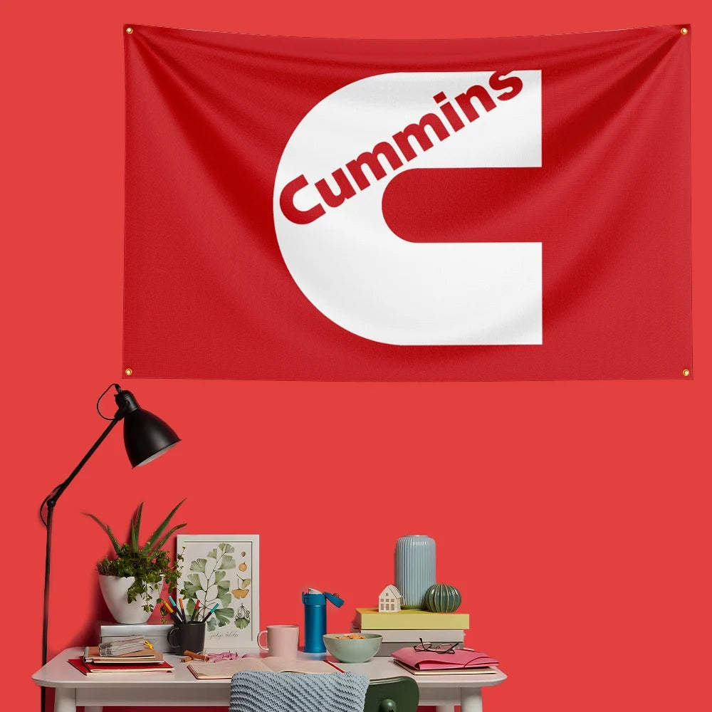 A red flag banner featuring the white letter C with red text Cummins on a red wall.