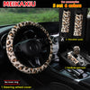 A set of leopard print car accessories including a steering wheel cover, shoulder pads, and a handbrake gear cover.