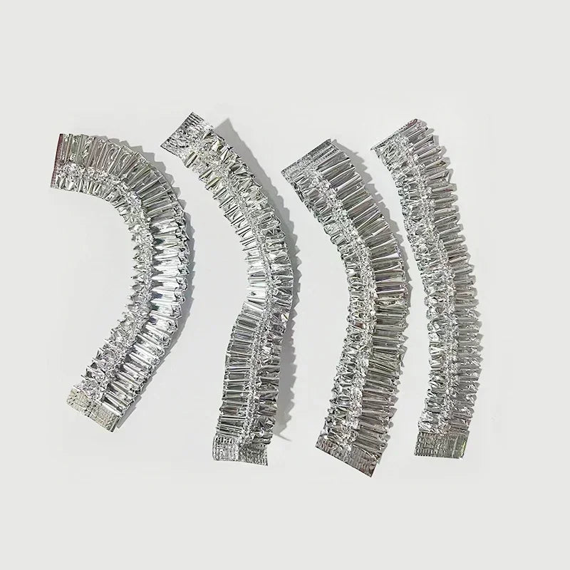 Four silver aluminum foil bowl covers arranged diagonally on a white background.