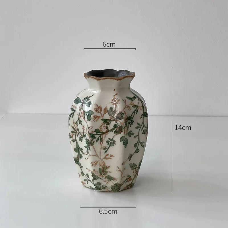 A white ceramic milk pitcher with a pastoral floral design and a cracked glaze, shown against a white background.