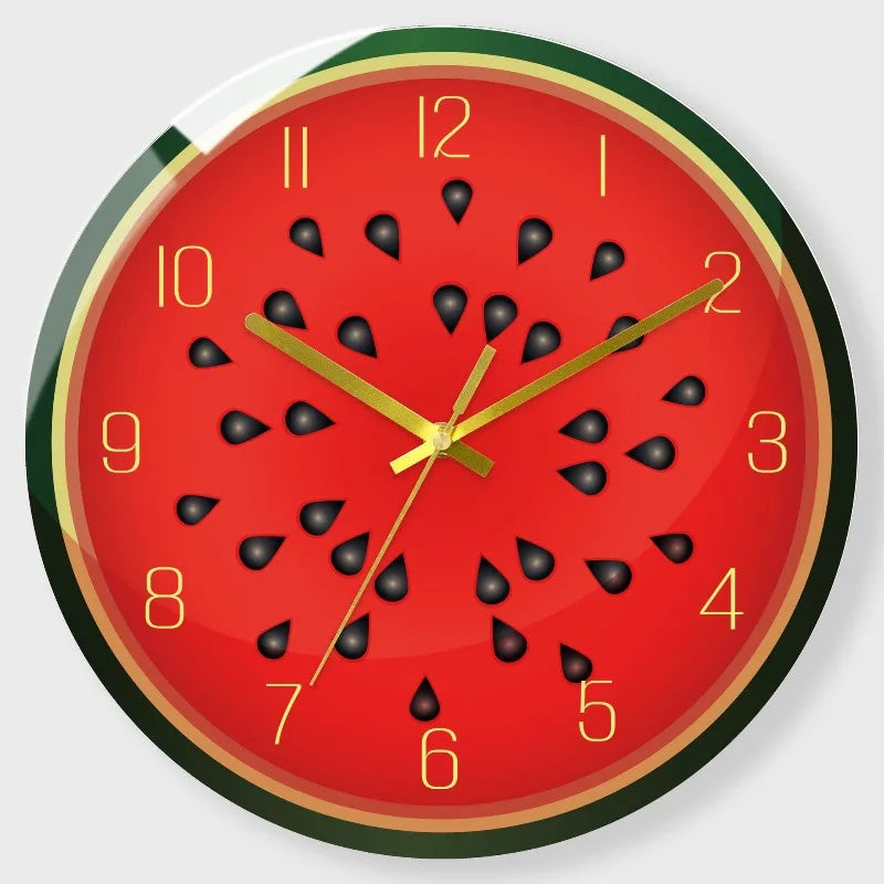 A round red clock face with black fruit designs and gold accents.