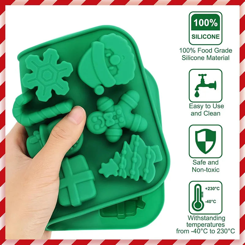 A hand holds a green silicone mold set featuring festive shapes for cookies and chocolate