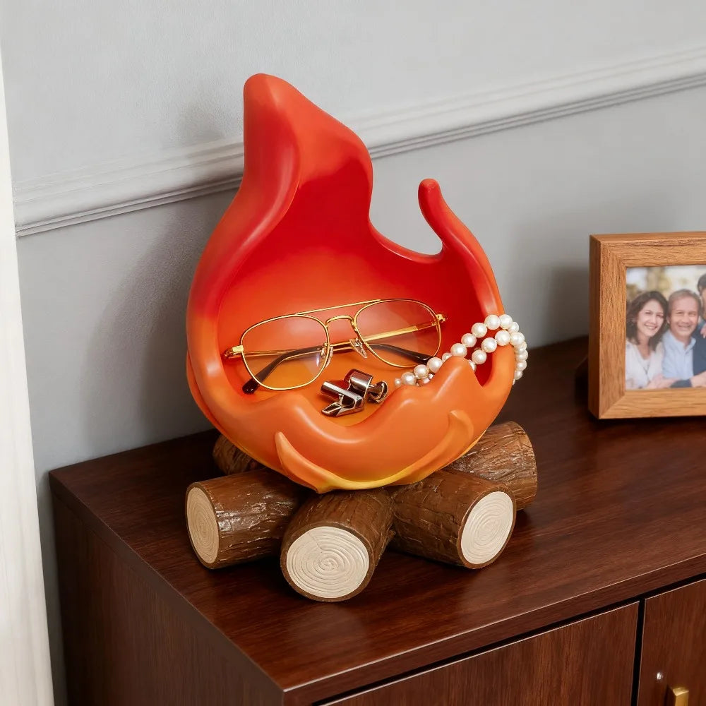 An anime-inspired orange fire spirit resin key tray and desk organizer resting on a dark wooden surface.