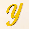 A yellow 3D acrylic letter Y is shown against a light background.