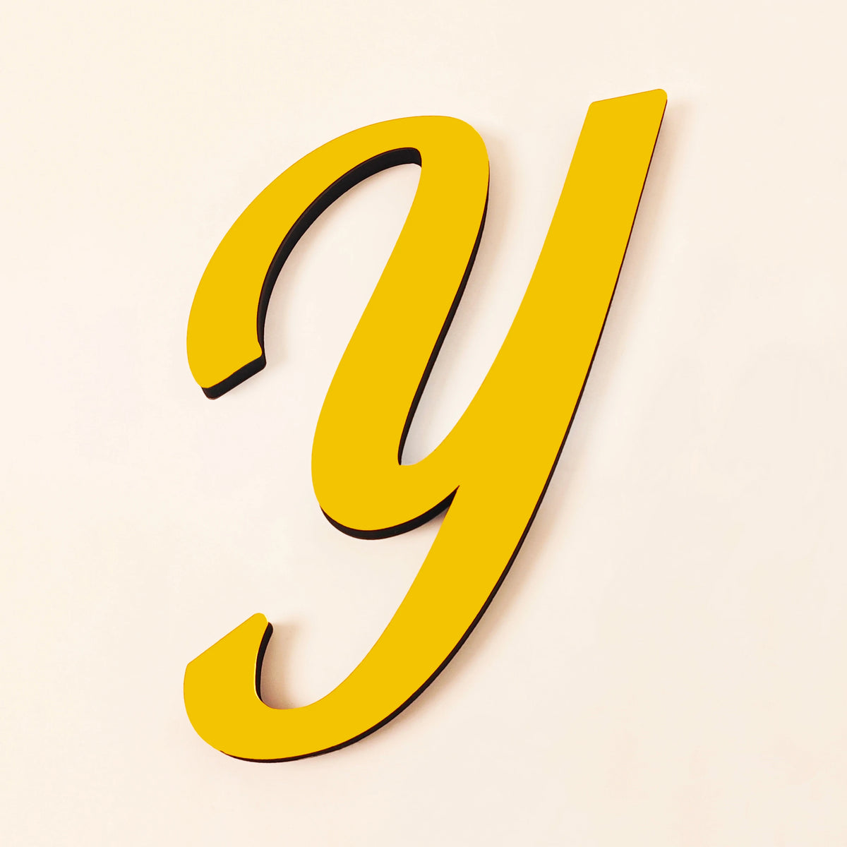 A yellow 3D acrylic letter Y is shown against a light background.