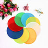 A collection of six colorful, round cooling fans in various shades of green, pink, red, blue, and yellow are displayed on a w