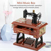 A brown wooden mini music box featuring a vintage sewing machine and storage lattice.