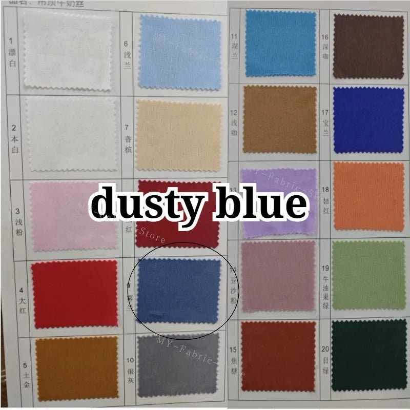 A collection of fabric swatches in various shades of dusty blue and related colors for textile purposes.
