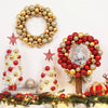 A festive display featuring a gold and silver silk Christmas ball wreath ornament surrounded by miniature decorated Christmas