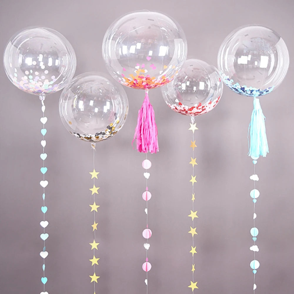 A collection of clear balloons with confetti and tassels in pink, blue, and yellow colors.