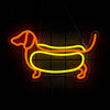A neon sign shaped like a dachshund dog in orange and yellow outlines hanging against a dark background.