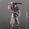 A figurine of Suguru Geto from Jujutsu Kaisen, dressed in dark clothing and holding a large sword.