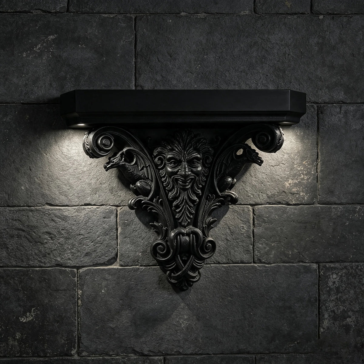A black ornate Gothic wall shelf with intricate carvings mounted on a dark stone brick wall.