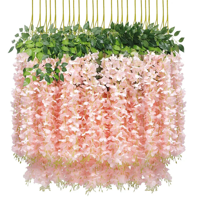 Artificial wisteria flower garland featuring pink and green foliage hanging in a planter.