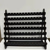 A black multilayer wooden earring organizer displaying jewelry.
