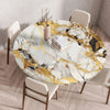 A round marble print tablecloth with gold veining is displayed on a wooden table surrounded by modern chairs.