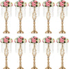 A set of gold crystal vases used for wedding centerpieces with pink and white floral arrangements.