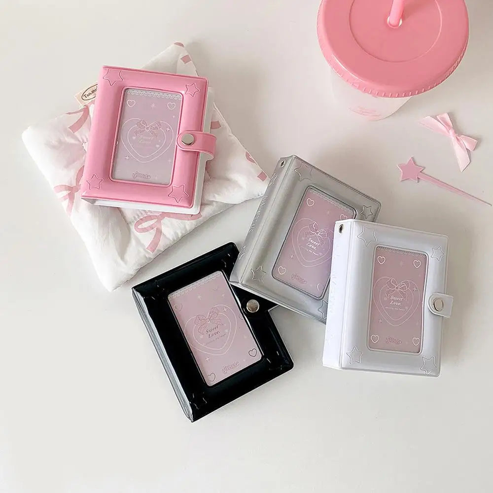 A collection of pink and silver compact photo card holders and an open pink lid on a white surface.