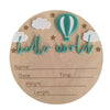 A natural wood birth announcement plaque featuring a teal hot air balloon, clouds, and the text hello world.