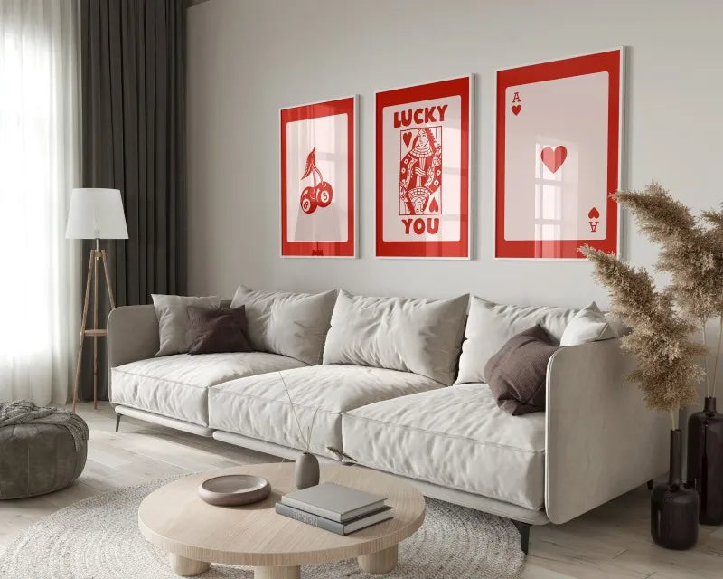 A modern living room featuring a light sofa, wooden coffee table, and framed retro letter art canvases on the wall.