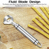 A silver fluid blade design peeler and cutter set is shown next to yellow noodles on a wooden surface.