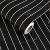 Roll of white self-adhesive 3D wood grain wall panels on a black marble surface.