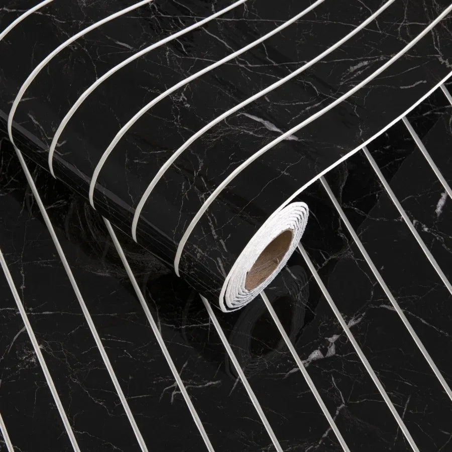 Roll of white self-adhesive 3D wood grain wall panels on a black marble surface.