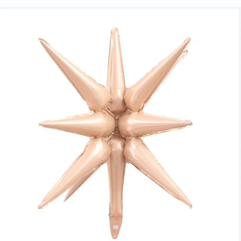 A cluster of light pink star burst foil balloons for party decoration
