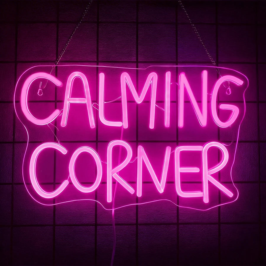 A neon sign spelling out CALMING CORNER in bright pink light against a dark grid background.